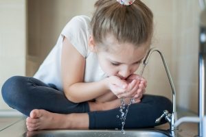 Caucasian,Little,Girl,Drinking,From,Water,Tap,Or,Faucet,In