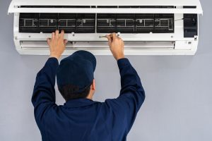 Technician,Service,Using,Screwdriver,To,Repairing,Air,Conditioner,Indoors